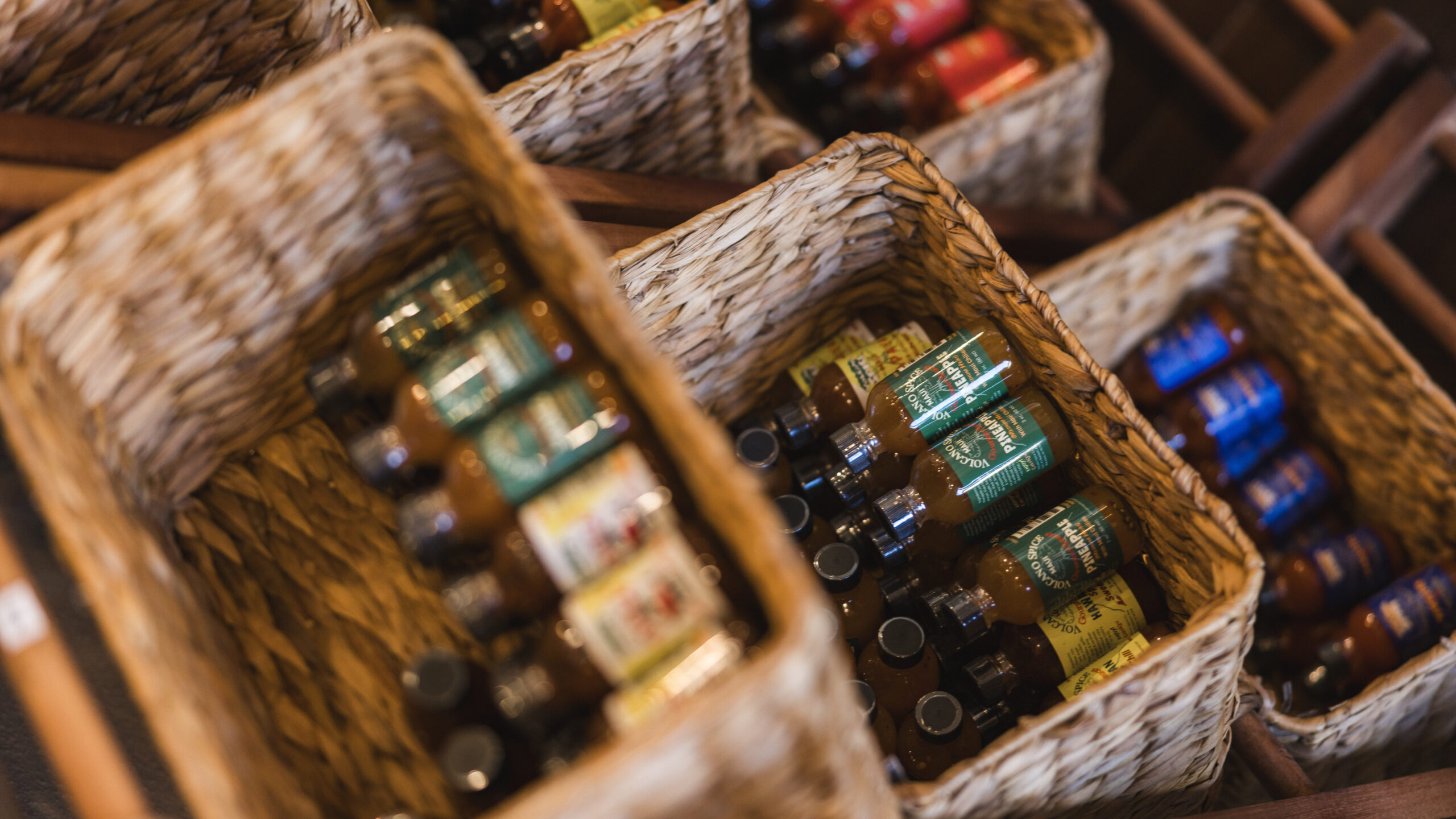 Baskets filled with various bottles of Volcano Sauce